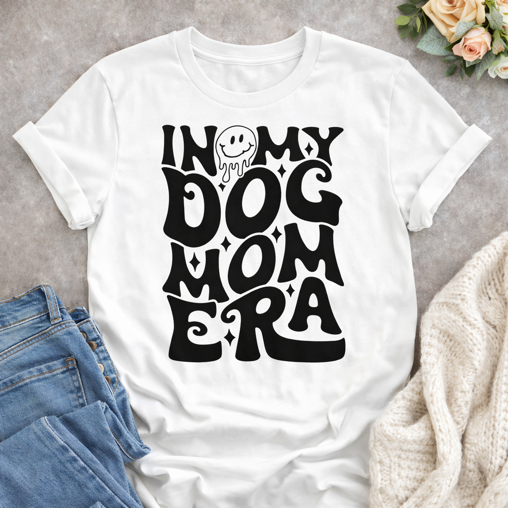 In My Dog Mom Era SVG design on white t-shirt flat lay with jeans and cozy blanket, dog mom Cricut SVG quote mockup
