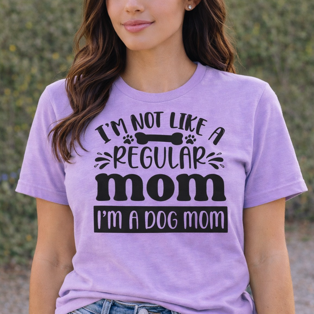 “I’m Not Like a Regular Mom I’m a Dog Mom” SVG Quotes design on purple T-shirt worn by woman, dog mom Cricut and Silhouette shirt idea