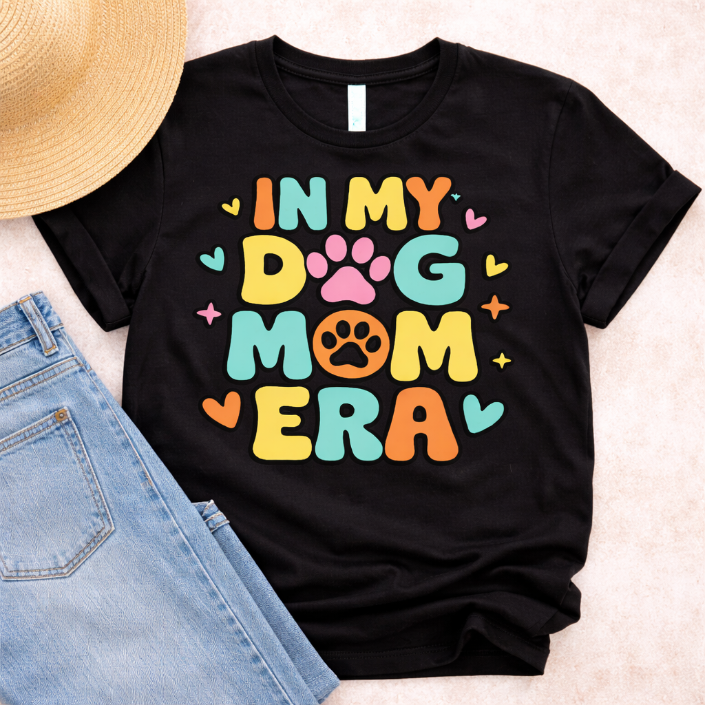 Black t-shirt with colorful In My Dog Mom Era SVG design featuring paw prints and hearts, styled with jeans and straw hat