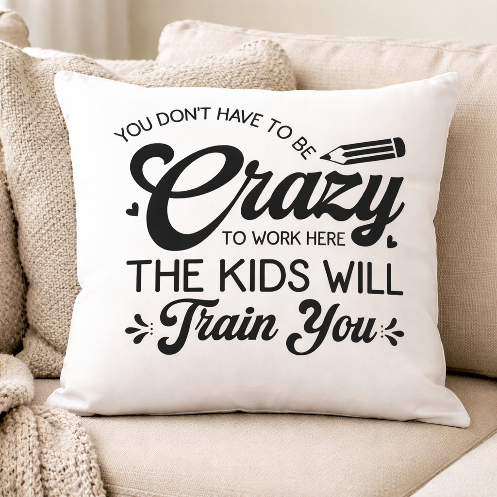 White pillow with “You don’t have to be crazy the kids will train you” SVG design in black, placed on beige sofa in cozy living room – Funny Teacher SVG Quotes