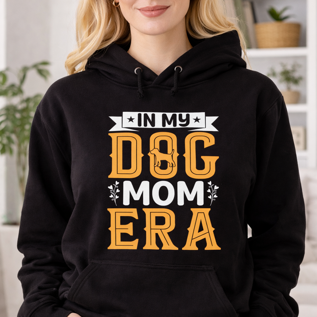 Black hoodie mockup worn by woman with In My Dog Mom Era SVG design, retro dog mom quote print on casual apparel in home interior