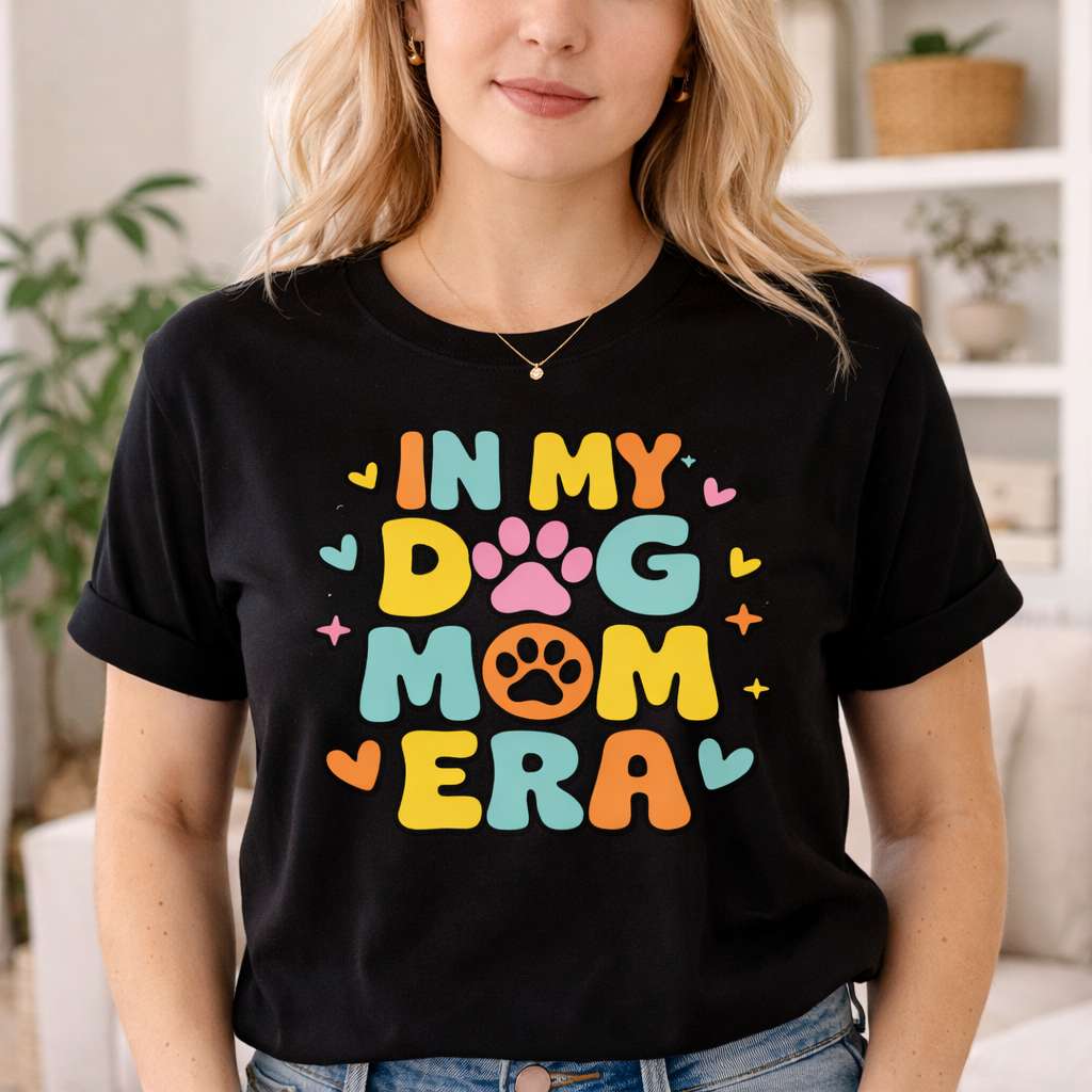 Woman wearing black t-shirt with colorful In My Dog Mom Era SVG design with paw print details in cozy indoor setting
