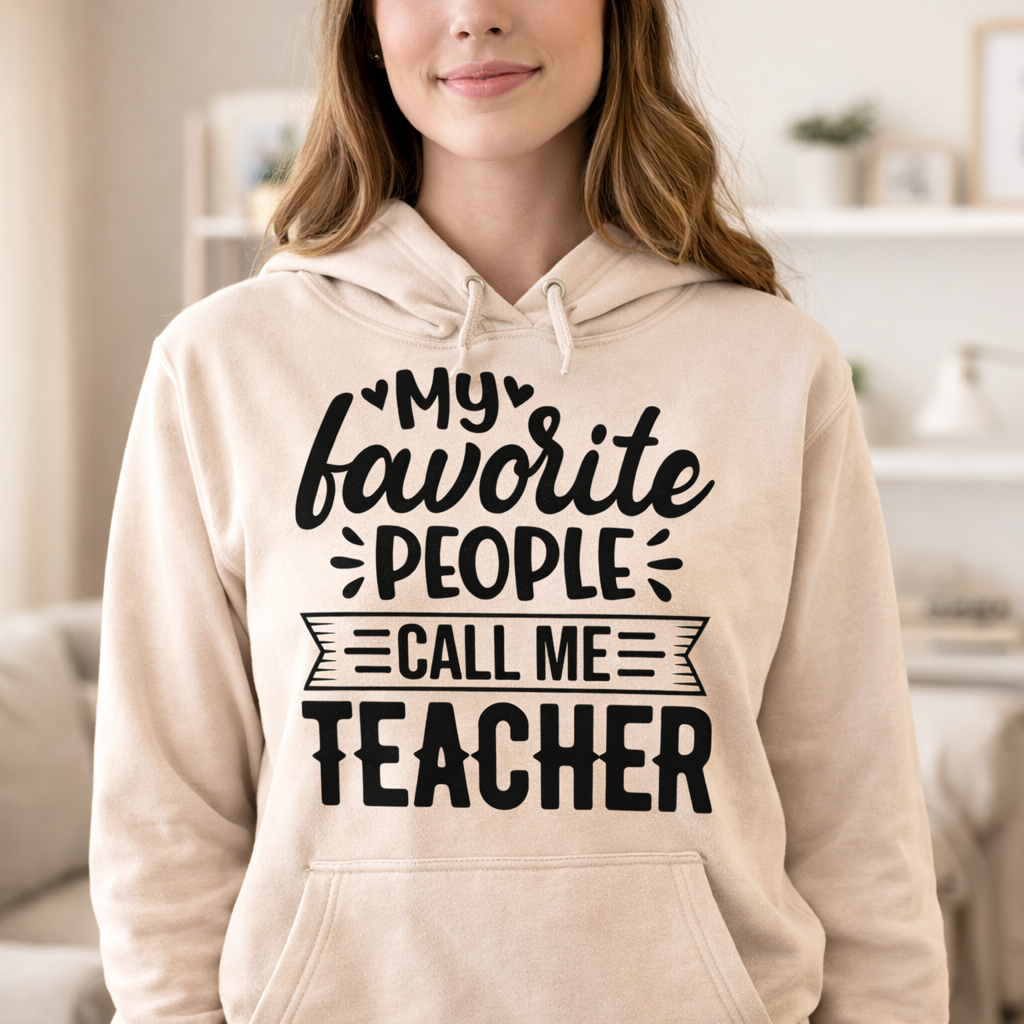 Woman wearing beige hoodie with “My favorite people call me teacher” SVG design in black, waist-up view in soft indoor setting – Funny Teacher SVG Quotes