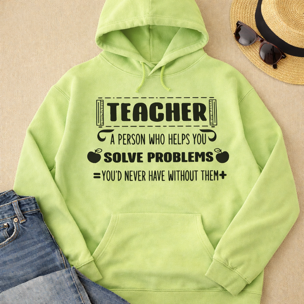 Light green hoodie with “Teacher a person who helps you solve problems” SVG design in black, flat lay with jeans, hat, and sunglasses on neutral background – Funny Teacher SVG Quotes