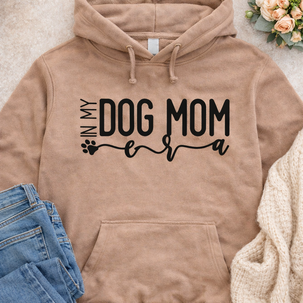 In My Dog Mom Era SVG quote design on beige hoodie mockup for Cricut and Silhouette DIY projects
