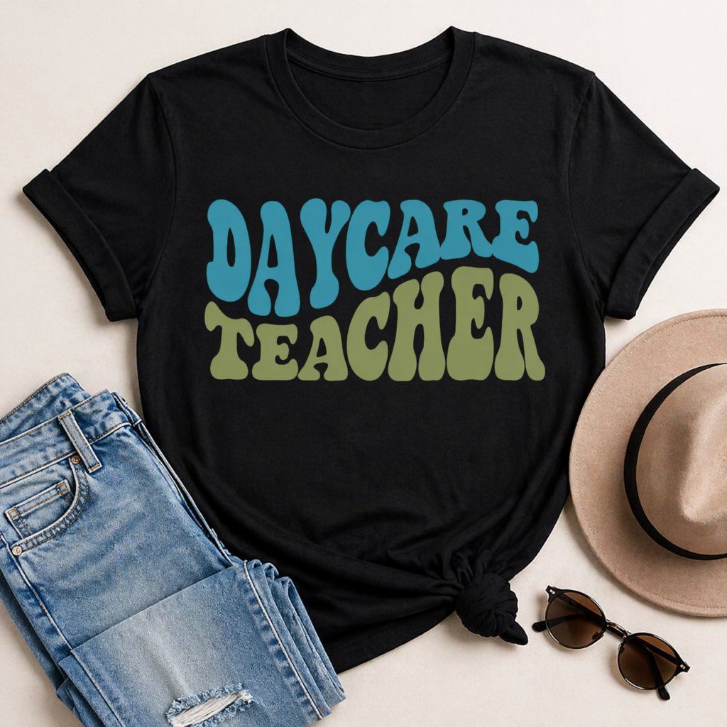 Black t shirt with Daycare Teacher SVG in retro style lettering placed with jeans hat and sunglasses in flat lay composition