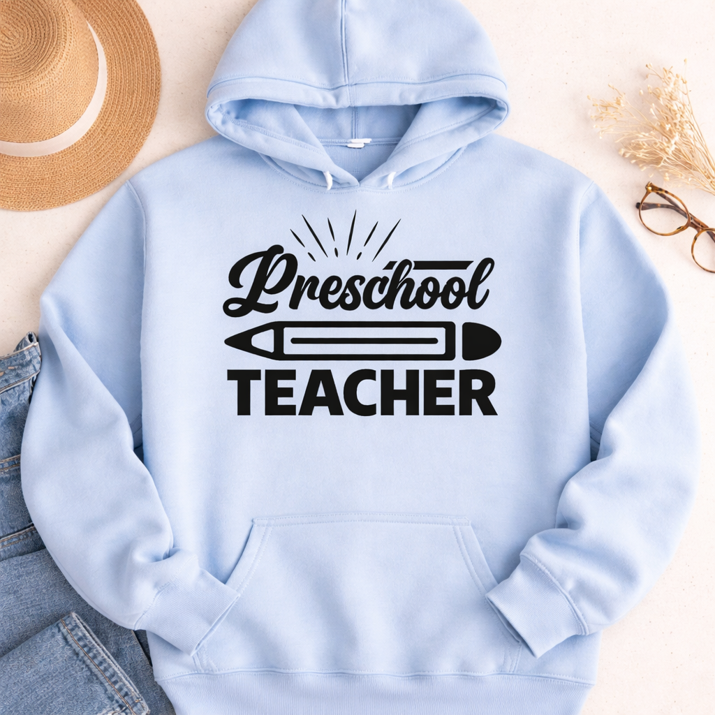 Light blue hoodie featuring Preschool Teacher SVG with pencil graphic and casual flat lay styling with jeans and accessories